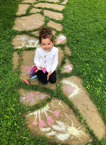 a student with her sidewalk chalk art