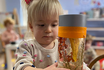 Little girl holding a homemade snow globe