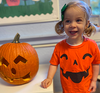 young girl with pumpkin