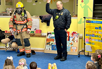 students listening to firefighters